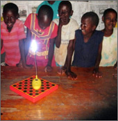 The children of Nyumbani Village, Kenya, smiling to see the solar lights